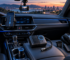 Useful car gadgets including a dash camera, tire inflator, charger, and phone mount inside a vehicle