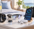 Wearable tech including a smartwatch, smart ring, fitness band, and smart scale on a clean surface
